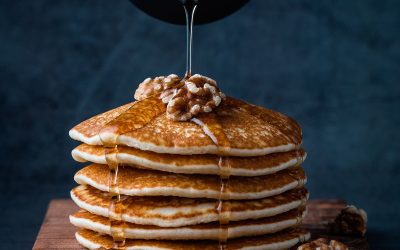 Foodiesfeed.com_pouring-honey-on-pancakes-with-walnuts